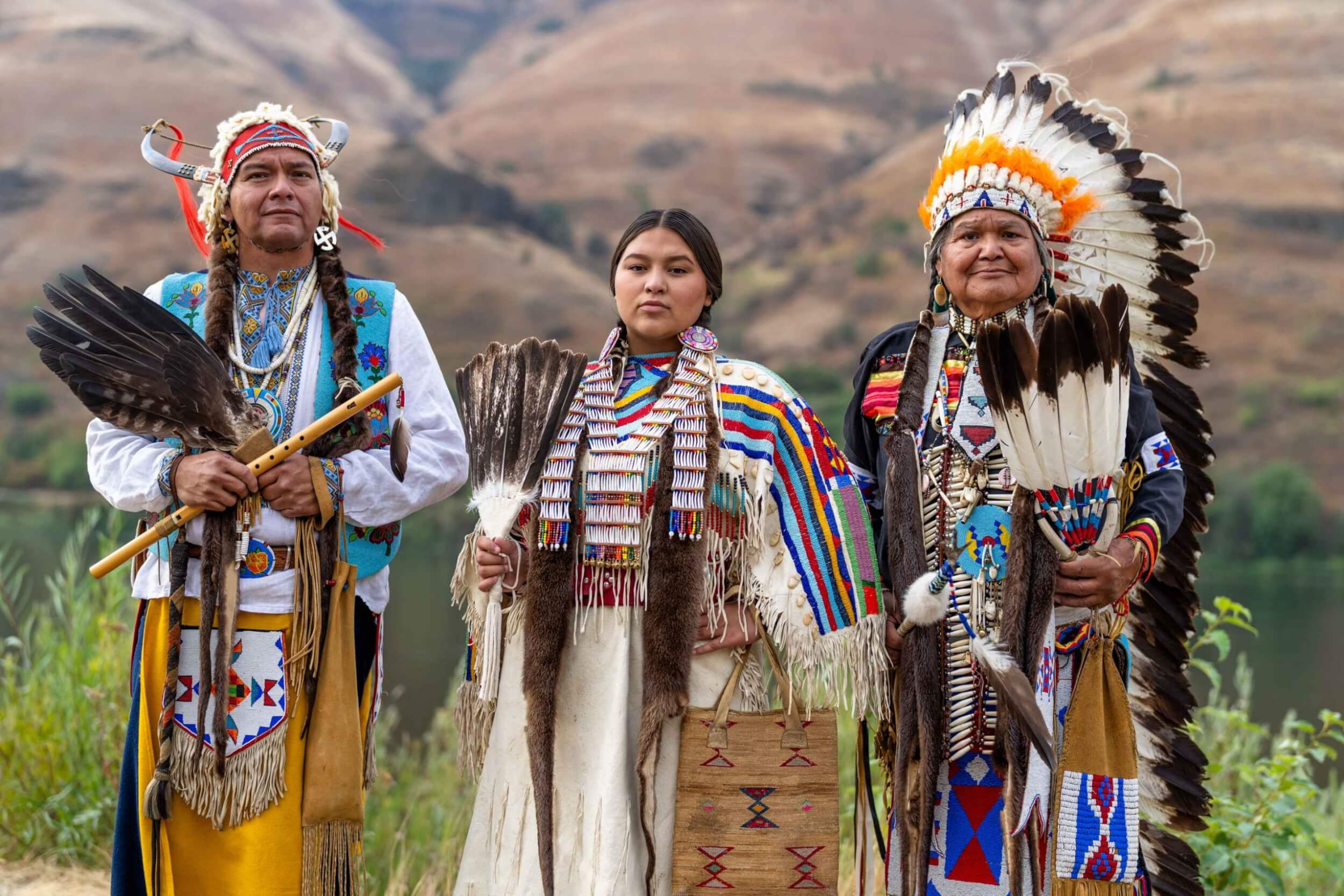 JR Spencer, Sayq'is Greene, and Don Powaukee in traditional Nez Perce regalia at the Clearwater River’s edge.