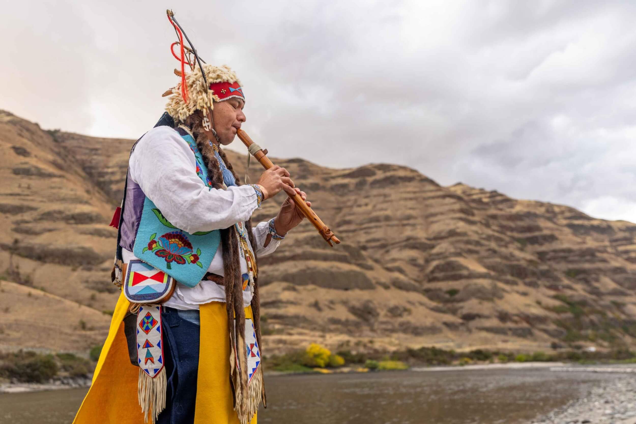 JR Spencer, a Nimiipuu storyteller, playing a traditional flute beside the Snake River.