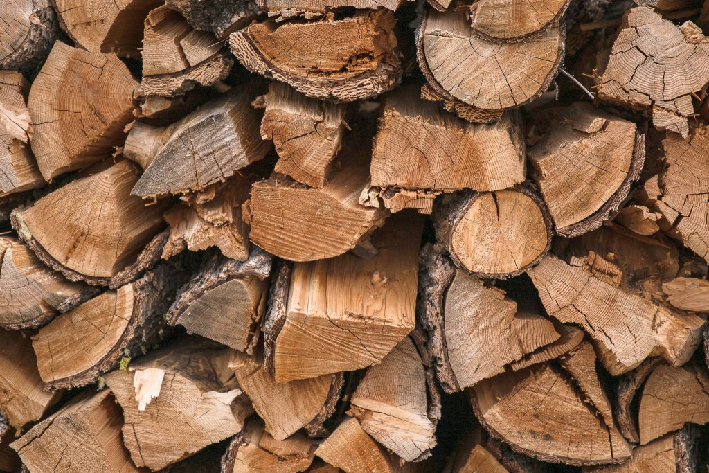 TRAVEL WITH CARE: CAMPFIRE SAFETY A stack of firewood.