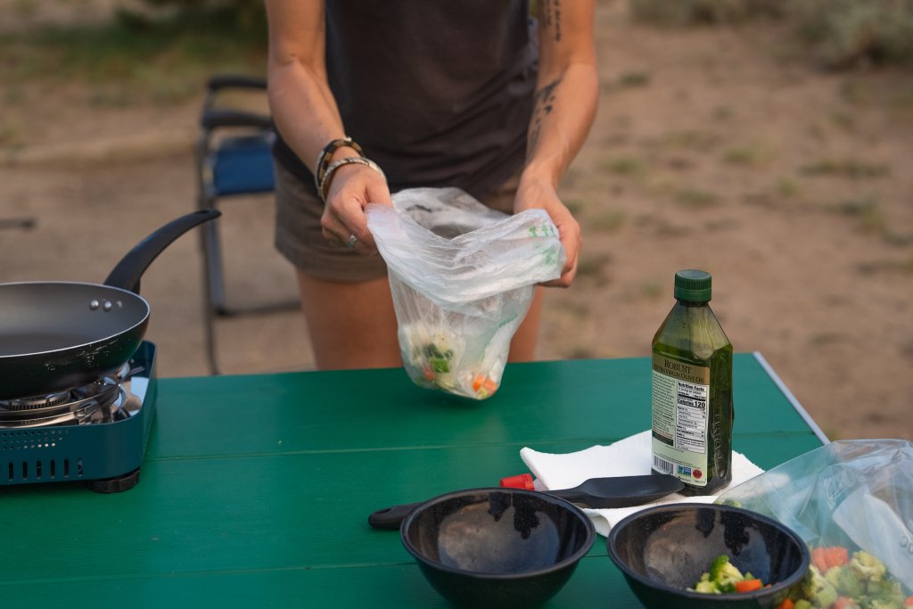 Travel With Care: Safety in Bear Country A camper disposes of food scraps safely to avoid an encounter with a bear.