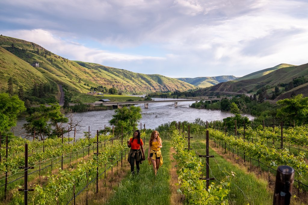 Two women walking through the Rivaura Estate Vineyard & Winery overlooking the Clearwater River.