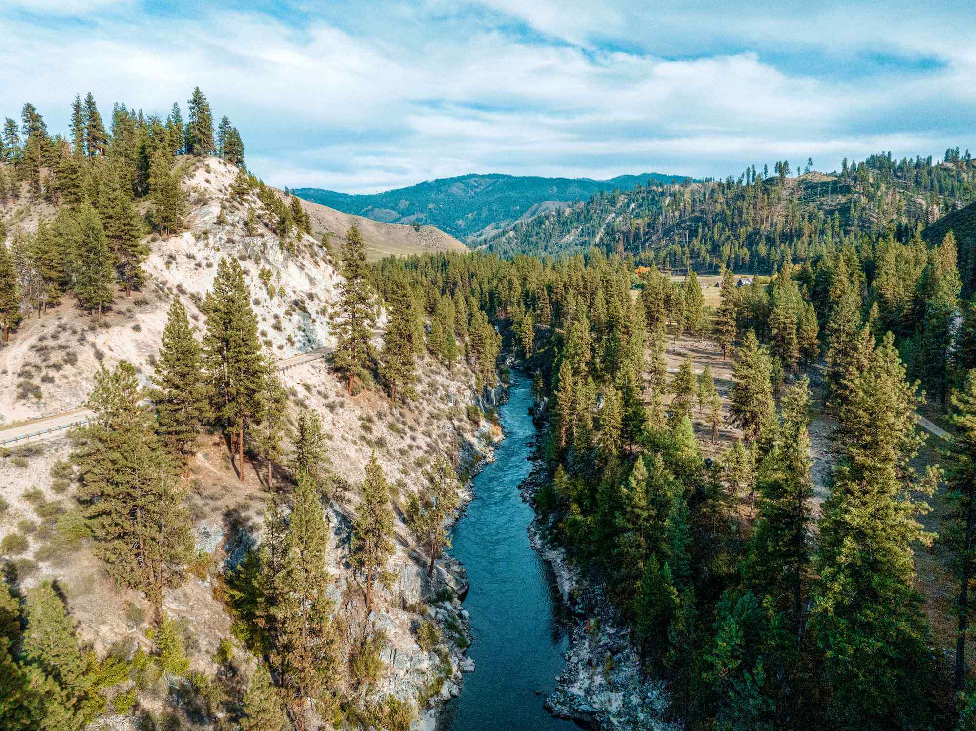 Aerial view of the Ponderosa Pine Scenic Byway following a river. 