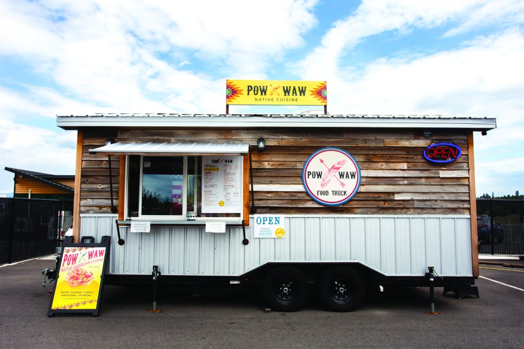 A food truck parked in a lot serving Native American inspired dishes.