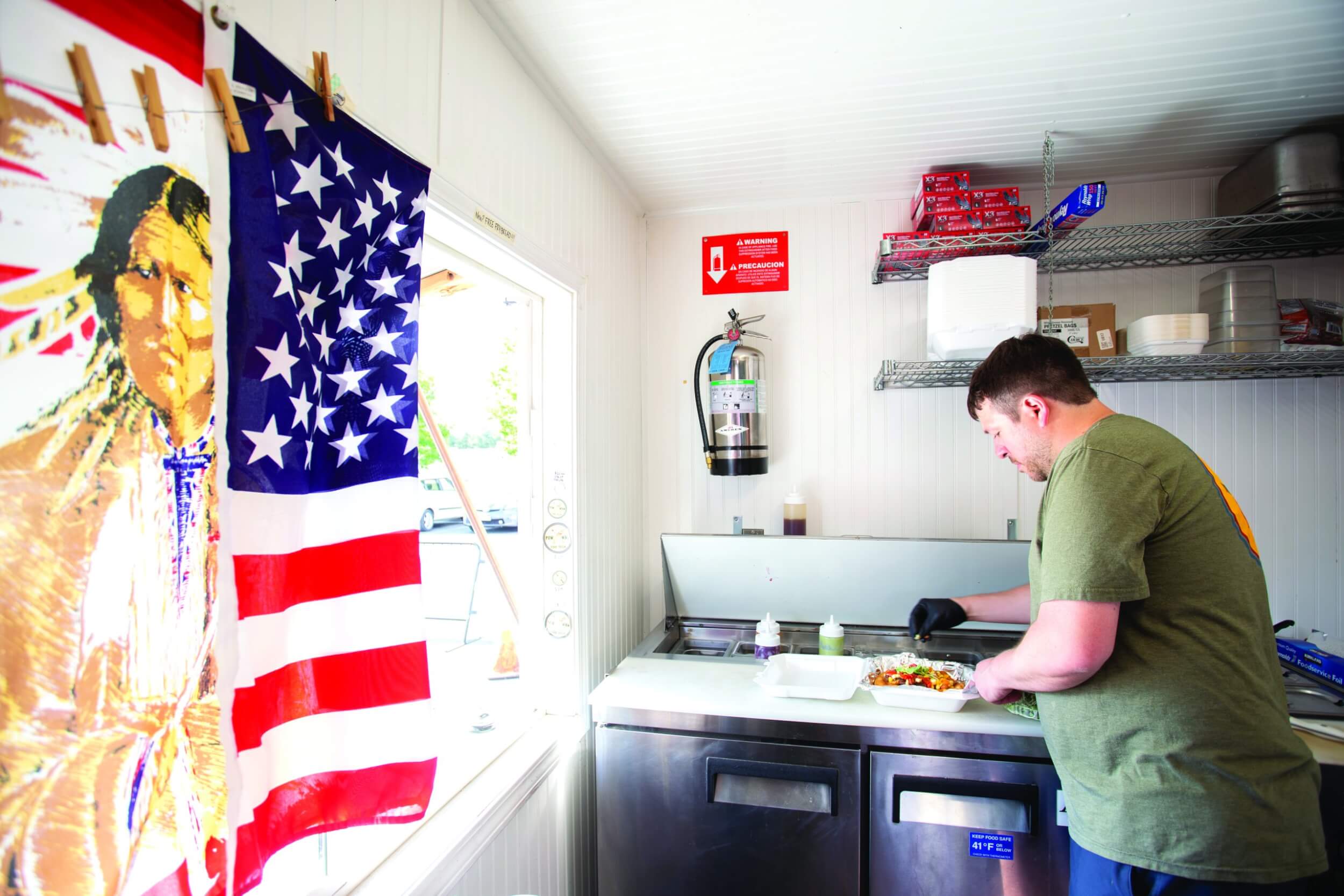 Chef Clark prepares to serve up food while working at the PowWaw Food Truck in Post Falls.