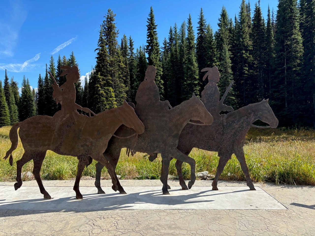 Life-size rusted steel silhouettes of mounted Nez Perce riders by artist Abe Yearout stand on the plaza of the Lolo Pass Visitor Center along the Idaho&ndash;Montana border.